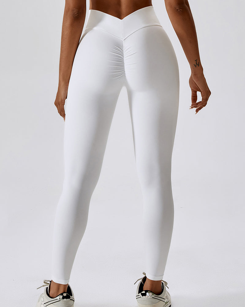 Leggings plisados ​​con costura en forma de V que moldean el cuerpo Pantalones de yoga para levantamiento de glúteos