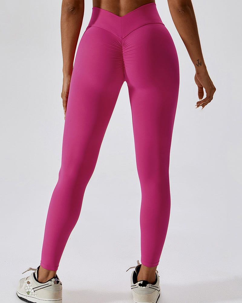 Leggings plisados ​​con costura en forma de V que moldean el cuerpo Pantalones de yoga para levantamiento de glúteos