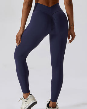 Leggings plisados ​​con costura en forma de V que moldean el cuerpo Pantalones de yoga para levantamiento de glúteos